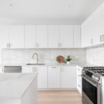 A,Beautiful,Kitchen,Detail,With,White,Cabinets,,A,Gold,Faucet,