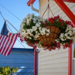 Beautiful,Flowers,In,A,Hanging,Basket,And,American,Flag,Flying