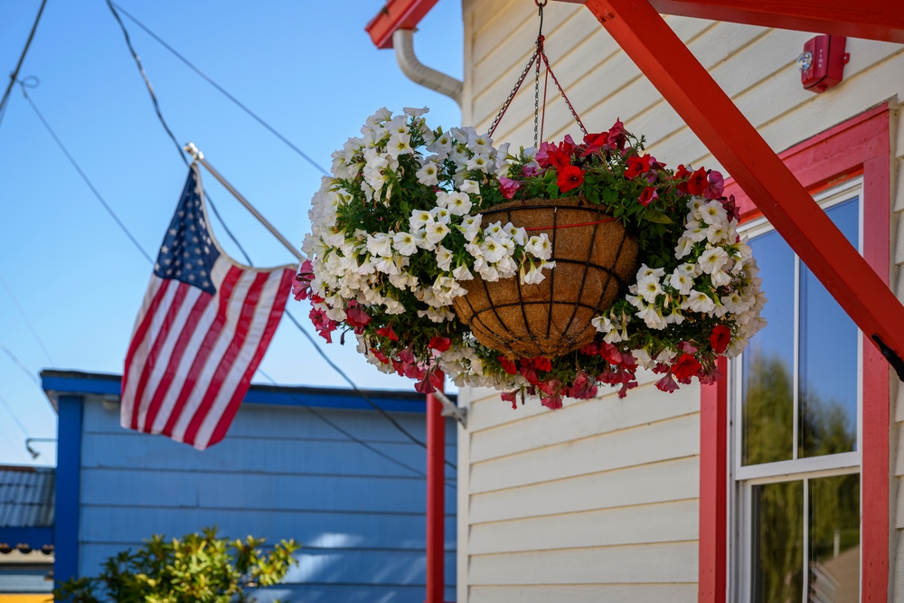 Beautiful,Flowers,In,A,Hanging,Basket,And,American,Flag,Flying
